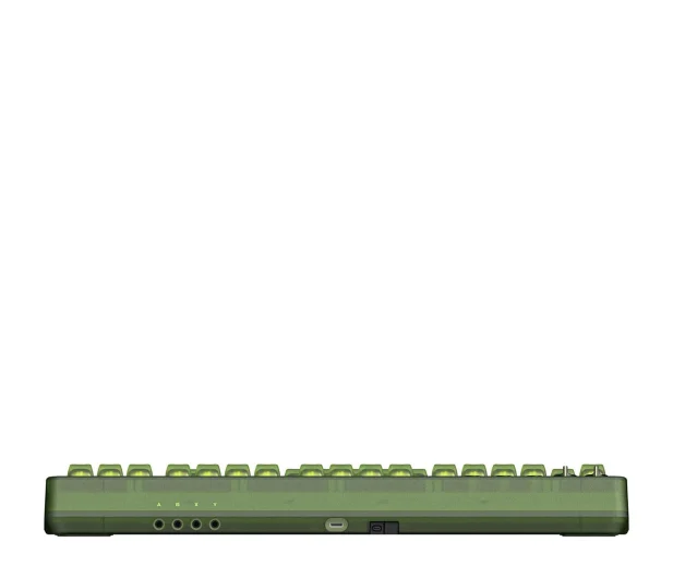 Zielona klawiatura retro, pokazująca bok z portem USB, na białym tle. Jest pozioma.