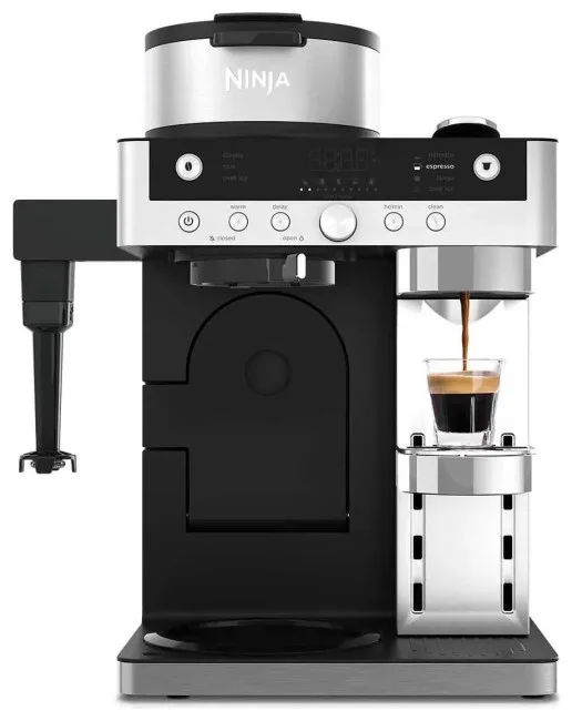 Czarna ekspres do kawy z srebrną górą, nalewa espresso do szklanki. Widoczne logo Ninja.