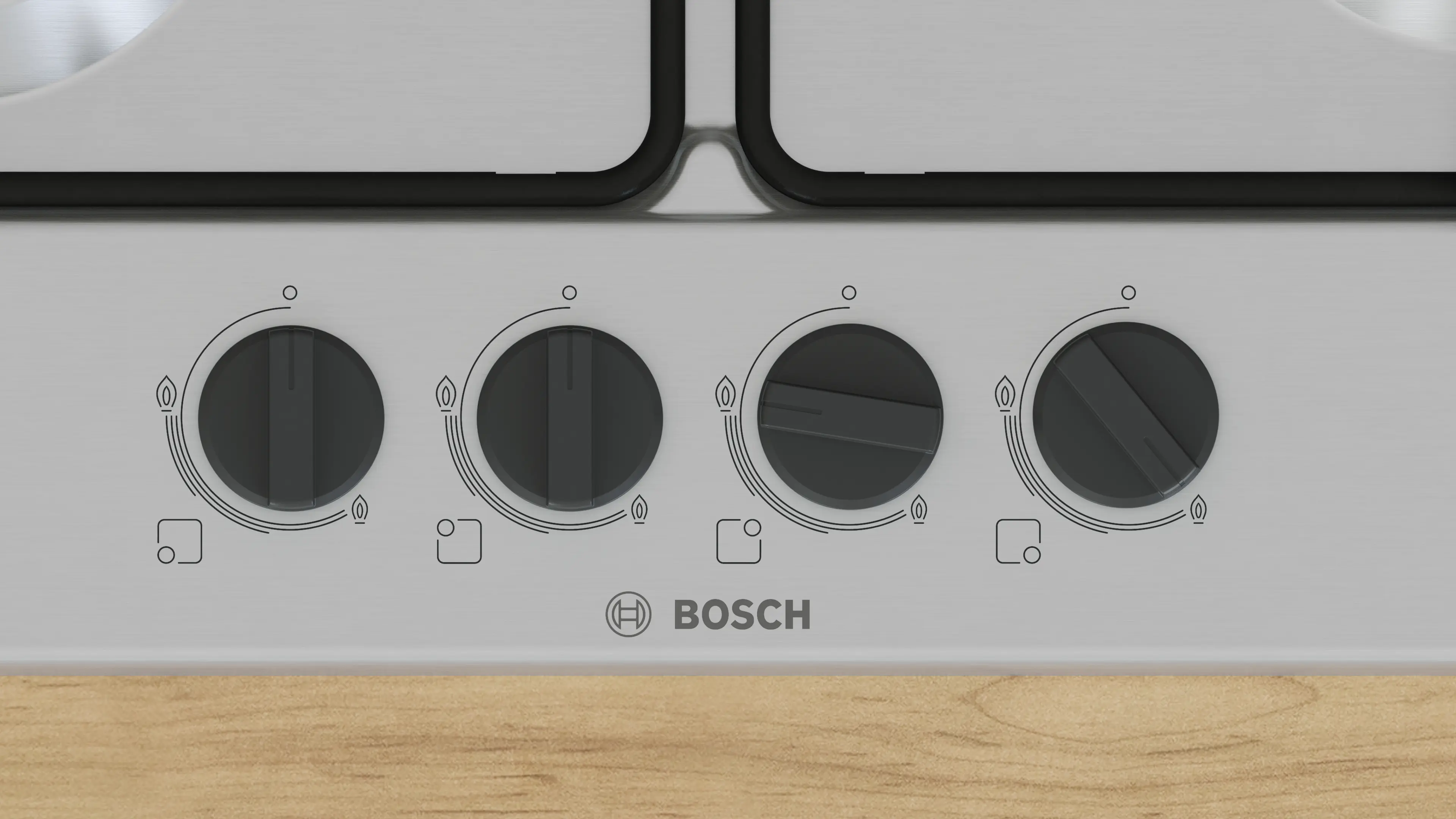 Zbliżenie panelu sterowania z pokrętłami do kuchenki gazowej z logo Bosch.