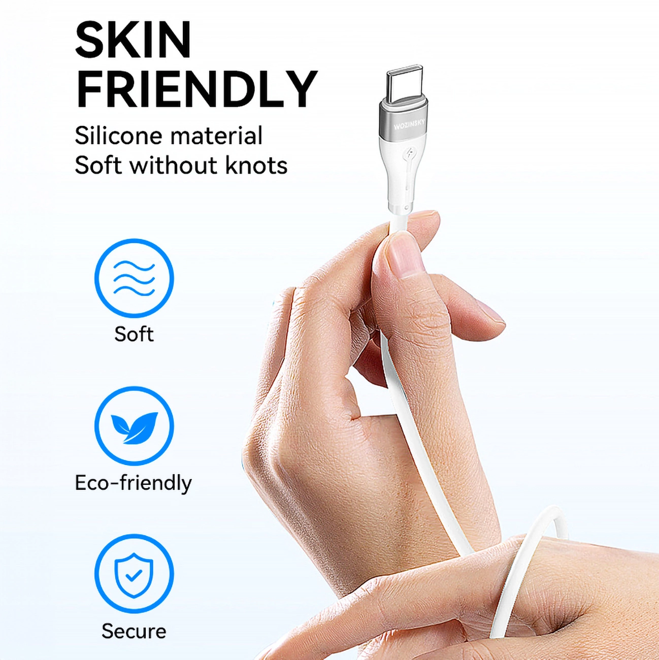 Ręka trzyma biały kabel USB-C. Tekst mówi 'Skin Friendly'. Widoczne ikony miękkie, ekologiczne i bezpieczne.