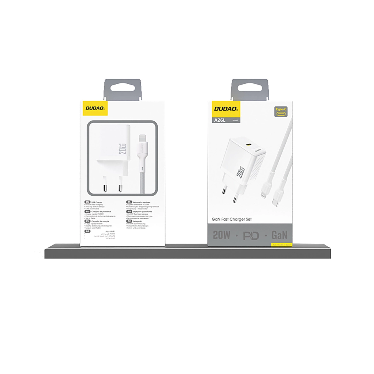 Dwa białe pudełka z ładowarkami z kablami na półce. Na jednym napis 'DUDAO 20W', na drugim 'GaN Fast Charger Set 20W'.