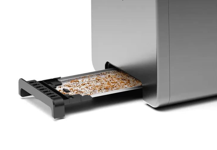 Close-up of a toaster with a crumb tray pulled out.