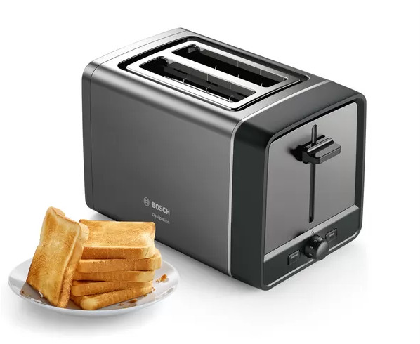 A grey toaster with two slots and a plate of toast next to it.