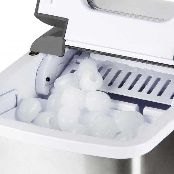 An ice machine with ice cubes, with the lid open.