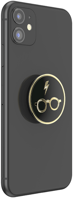 Een zwarte telefoon met een Harry Potter PopSocket, met bril en bliksemontwerp.