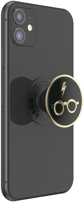 Zwarte telefoon met een Harry Potter PopSocket. Gouden accenten en een bliksemschicht.