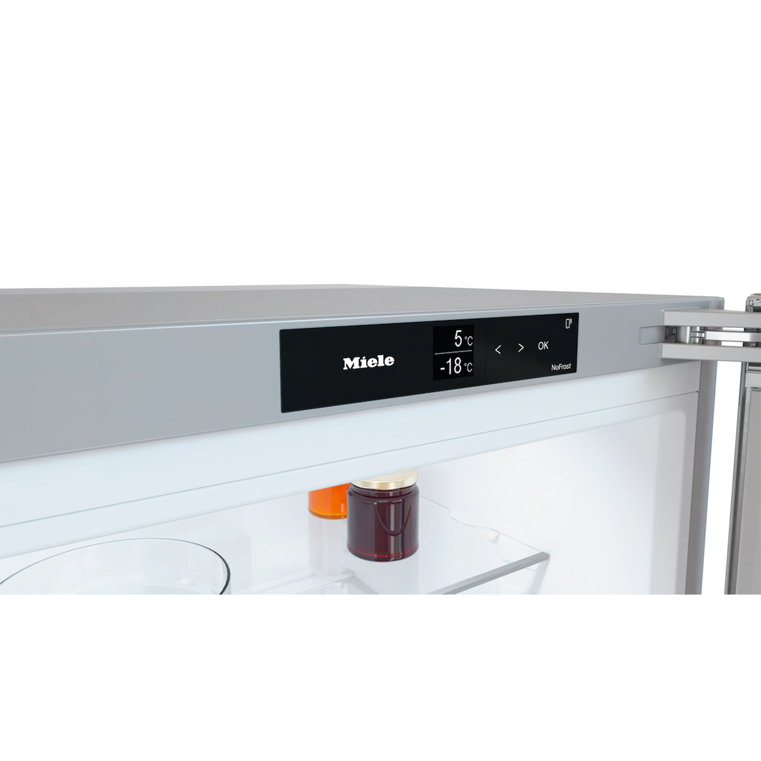 Display del frigorifero che mostra 'Miele' e temperature. Ci sono barattoli all'interno del frigo.