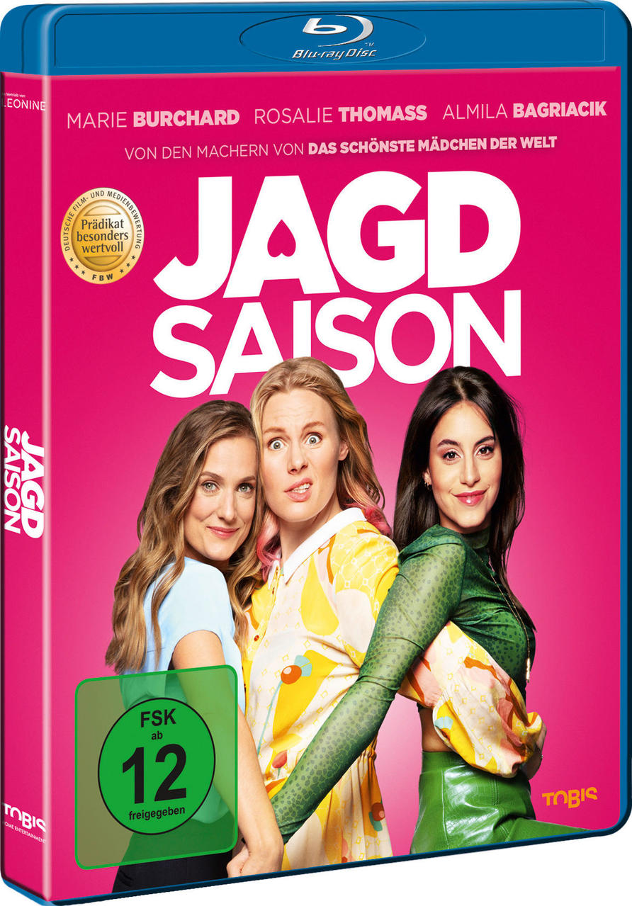 Blu-ray-Cover des Films "Jagd Saison" mit Gesichtern dreier Frauen, rosa Hintergrund.
