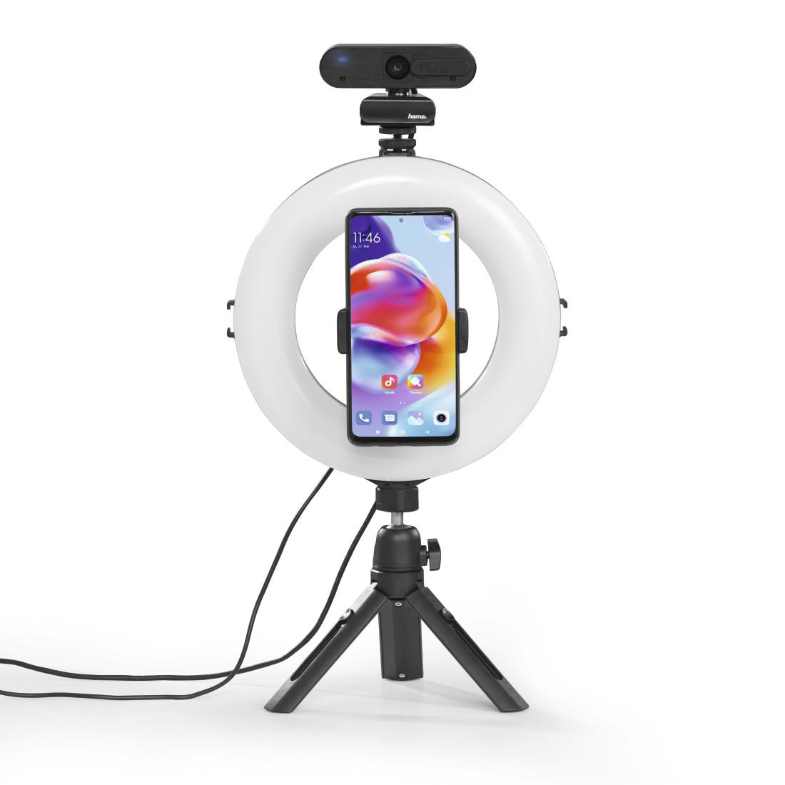 Ringlicht mit Telefon und Webcam in der Mitte, montiert auf einem Stativ auf weißem Hintergrund.