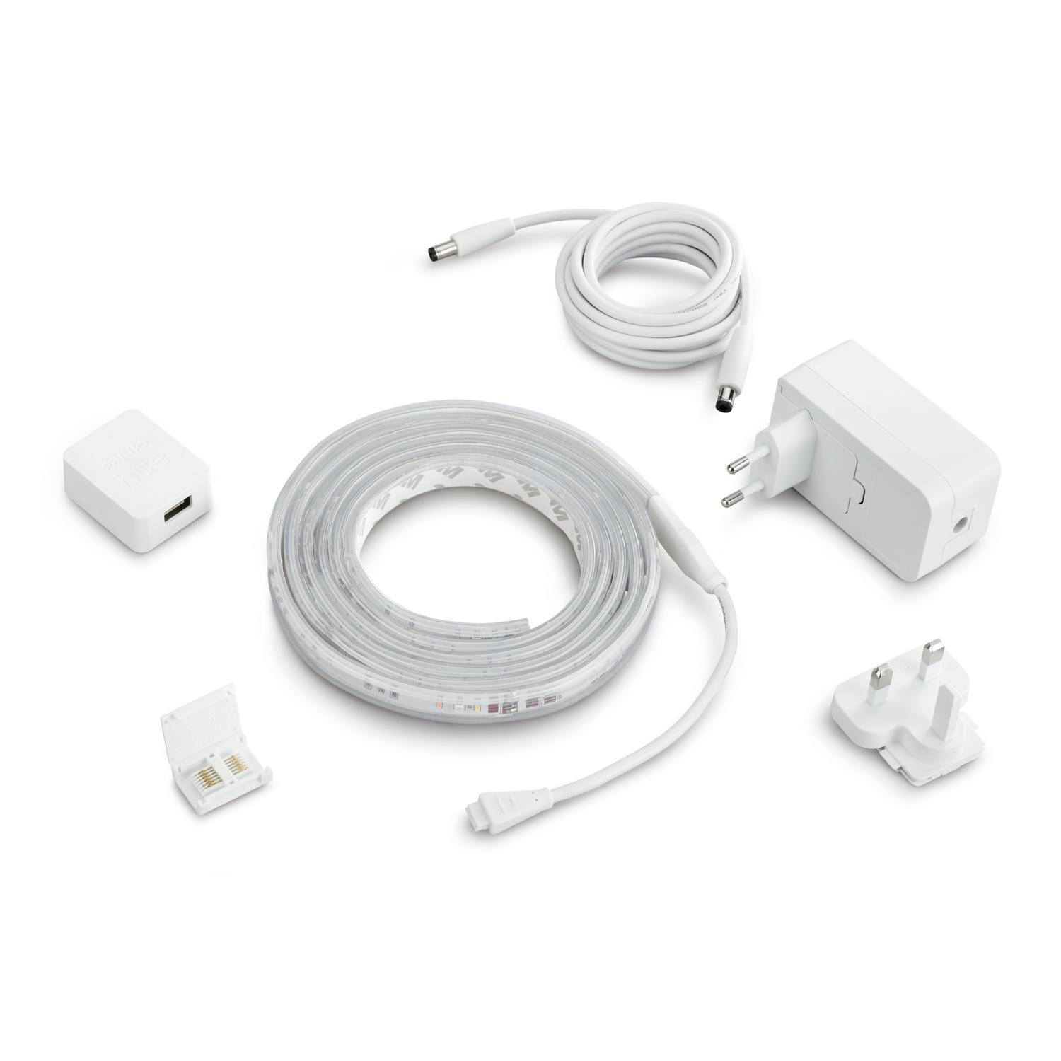Weiße Lichtleisten-Komponenten: Streifen, Adapter, Anschlüsse und Netzteil.