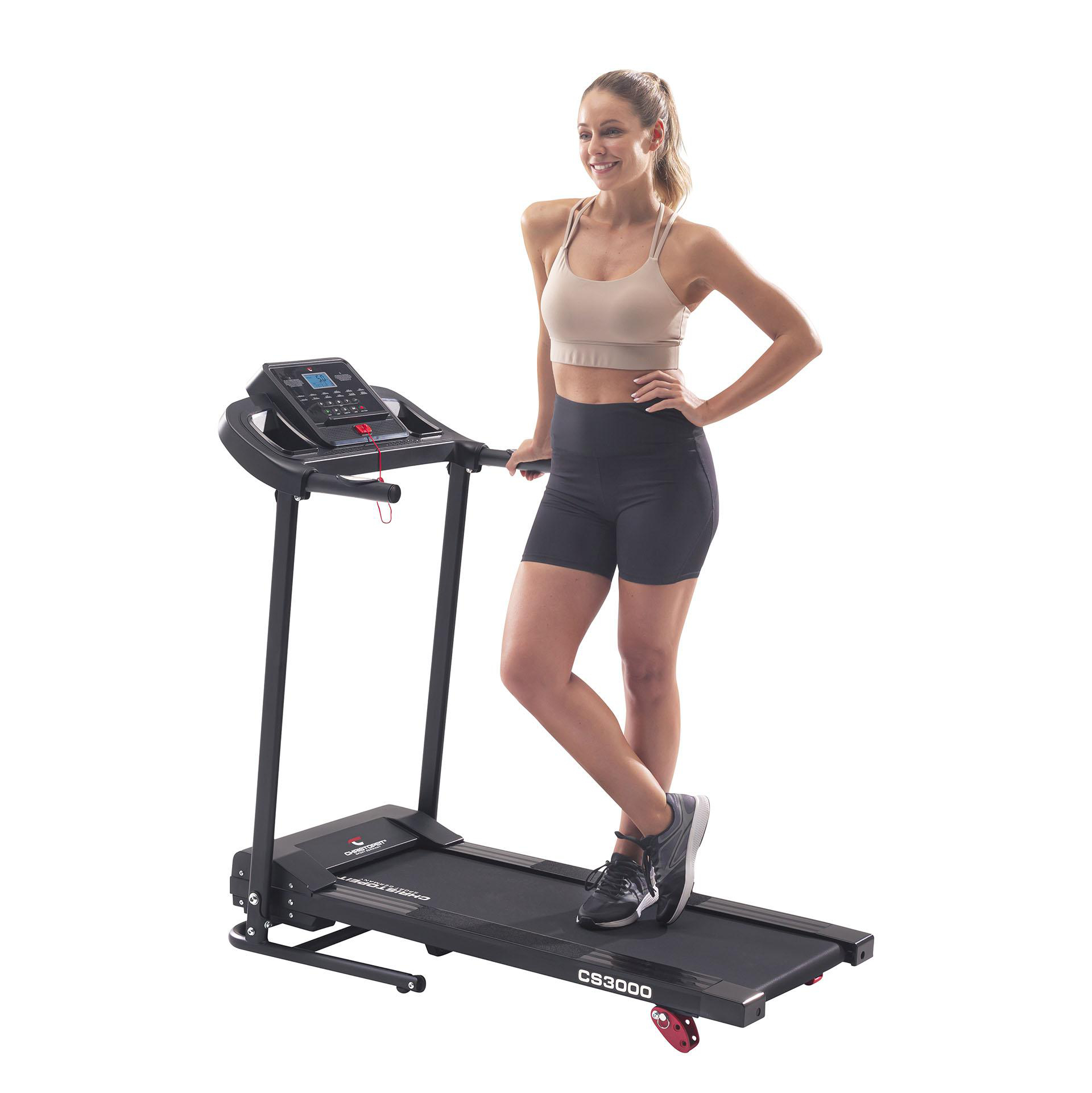 Frau auf einem Laufband lächelnd, in Sportkleidung, in einem Studio.