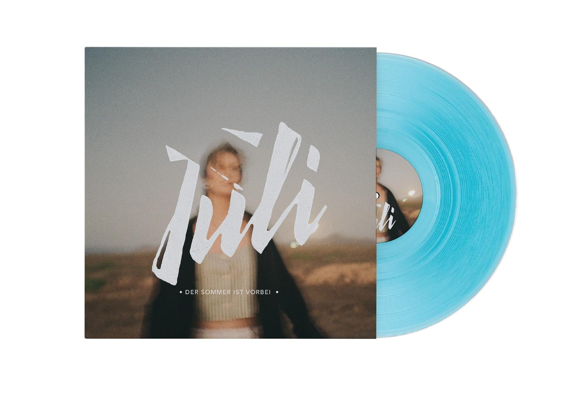 Albumcover mit verschwommener Frau, Titel 'Juli' und einer blauen Vinylplatte.