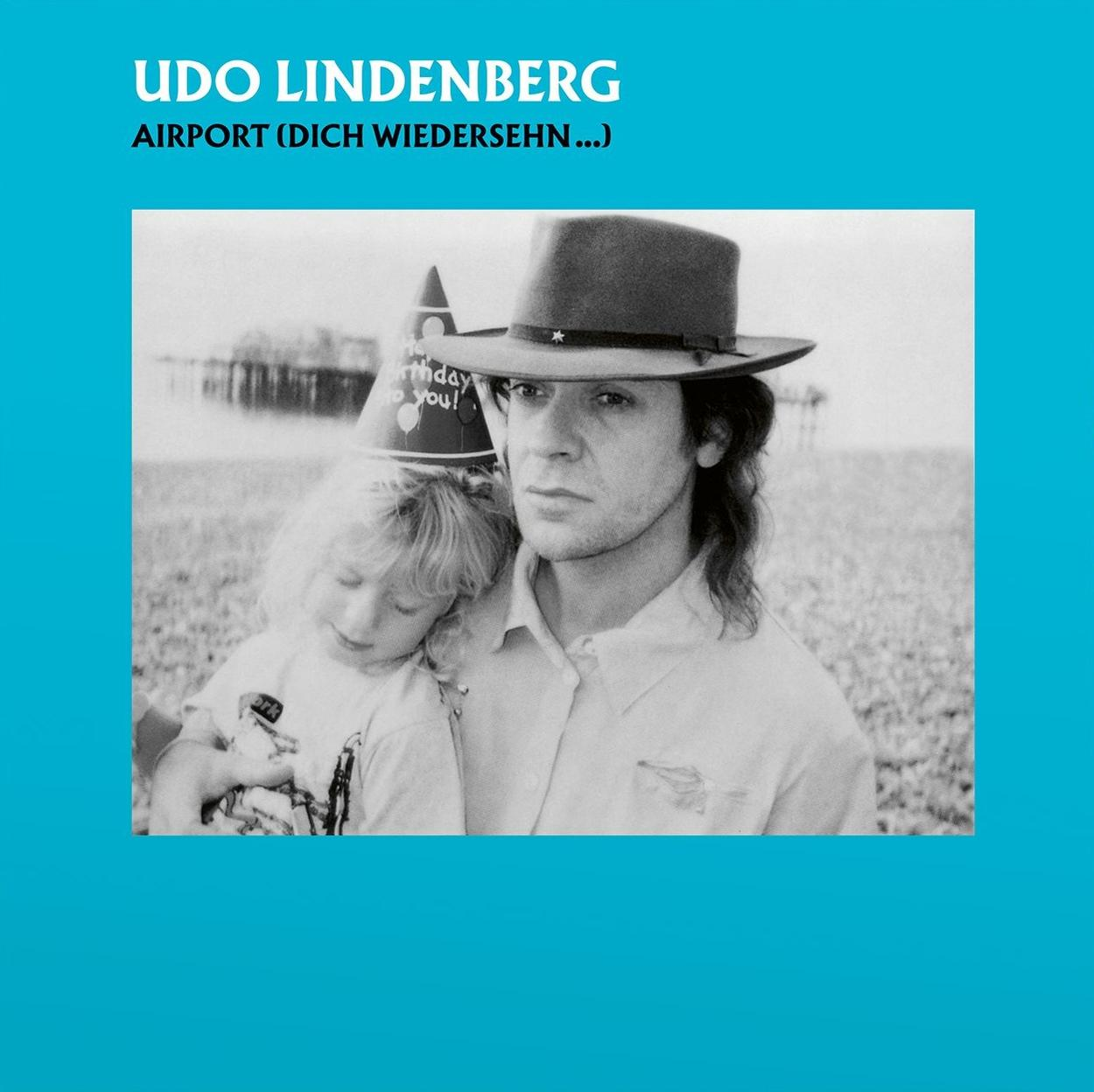 Albumcover: Udo Lindenberg mit Kind, Hut und Geburtstagshut, blauer Hintergrund.