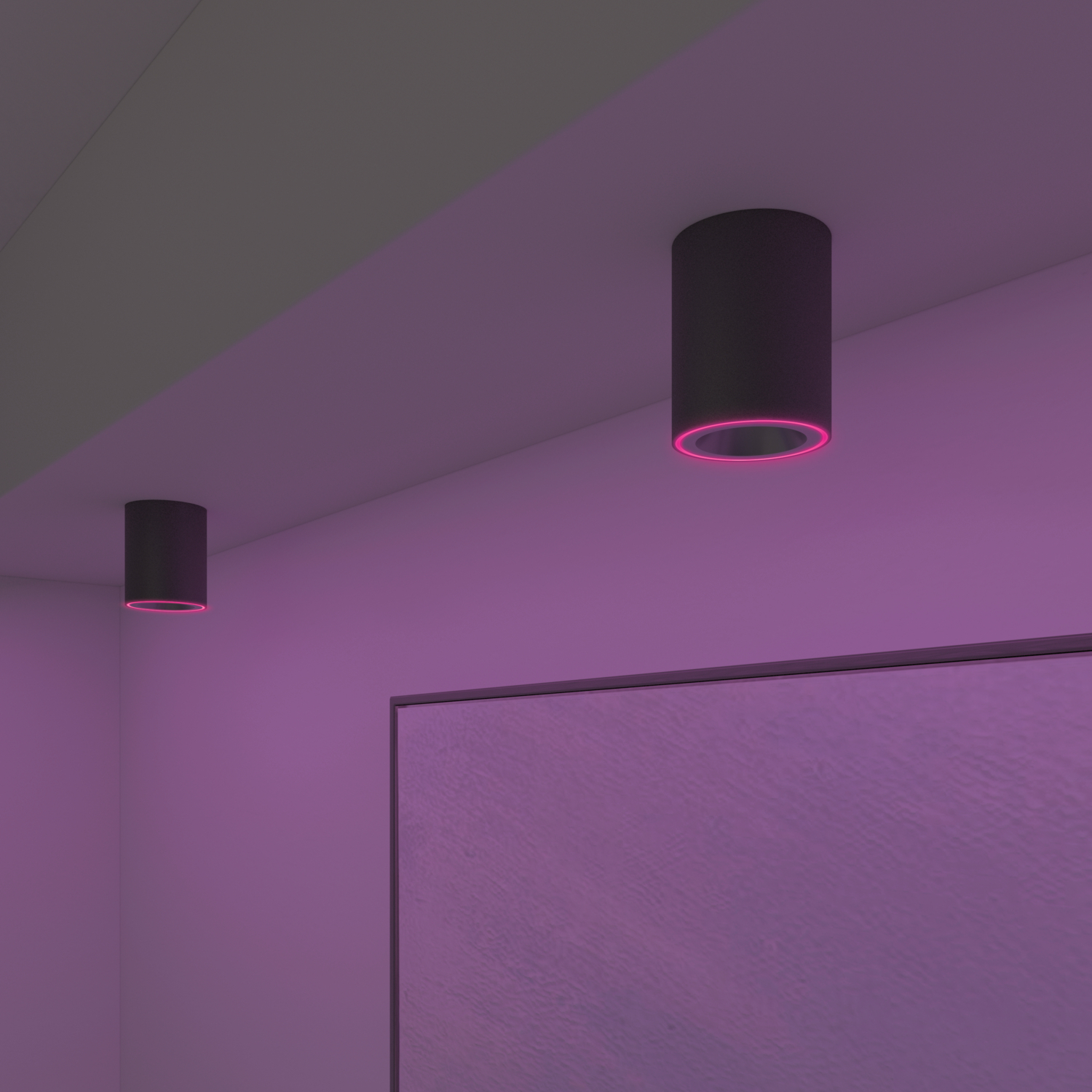 Two black cylindrical lights with pink edges. The lights are mounted on a white ceiling. A large screen is below.