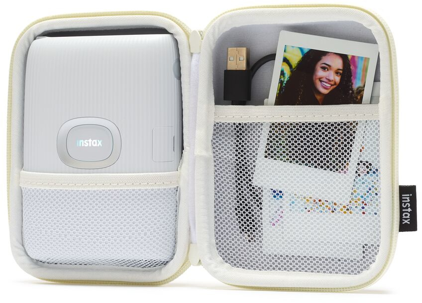 White Instax printer in a matching case. A photo and charging cable are in a pouch.