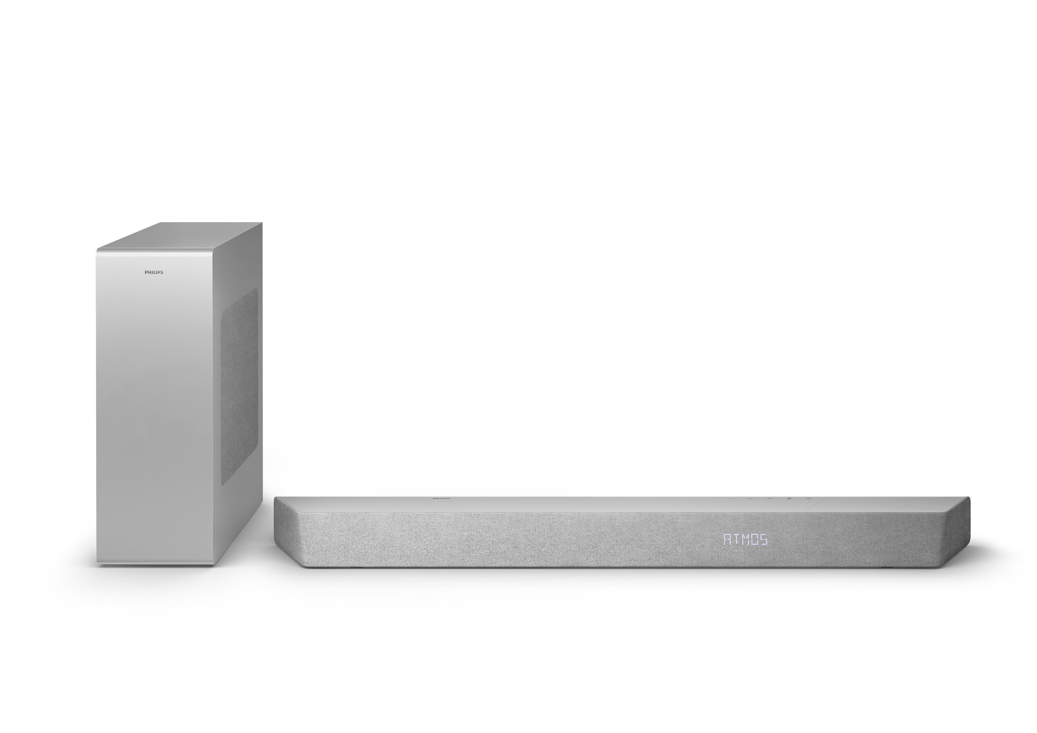 Silberne Soundbar mit ATMOS-Text und Subwoofer auf weißem Hintergrund.