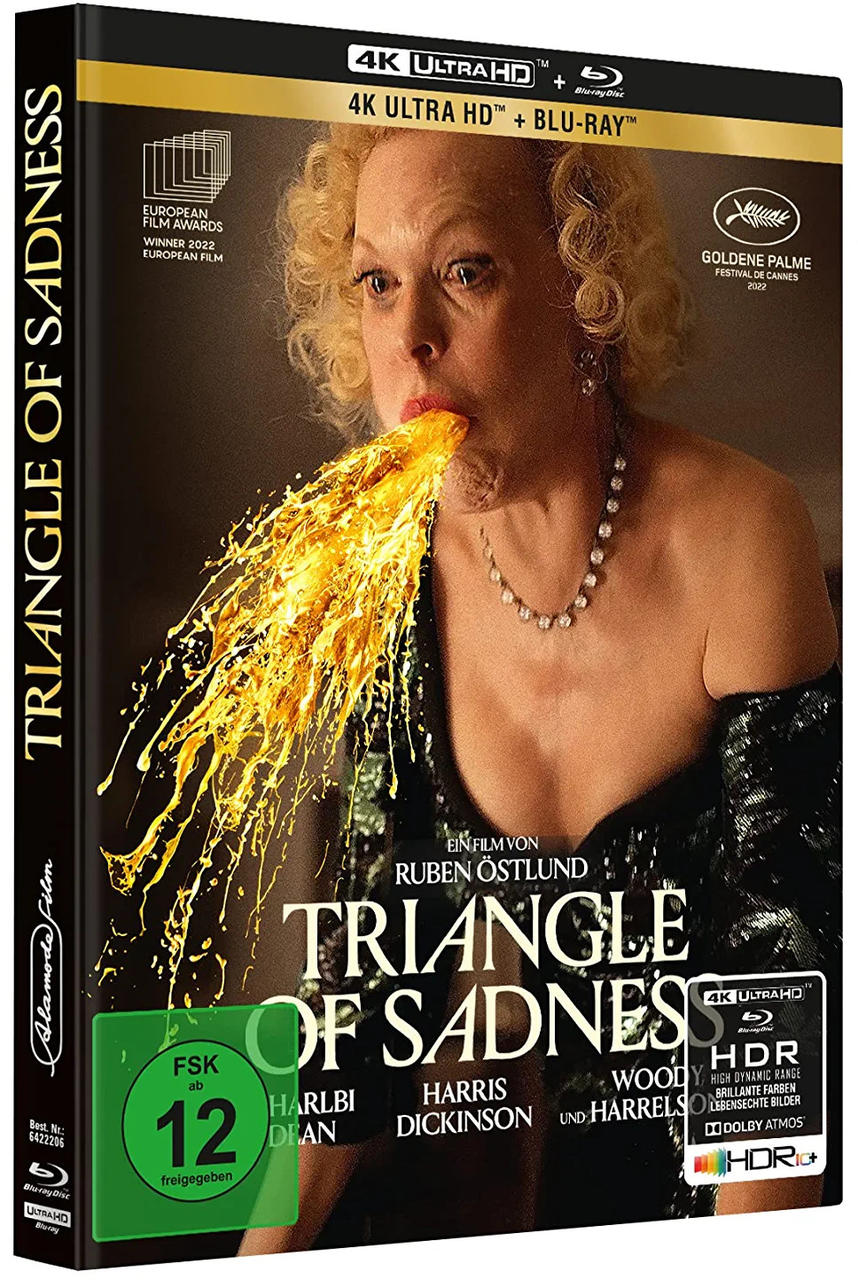 Filmcover von 'Triangle of Sadness'. Eine Frau erbricht Feuer. Schwarze Box mit Text.