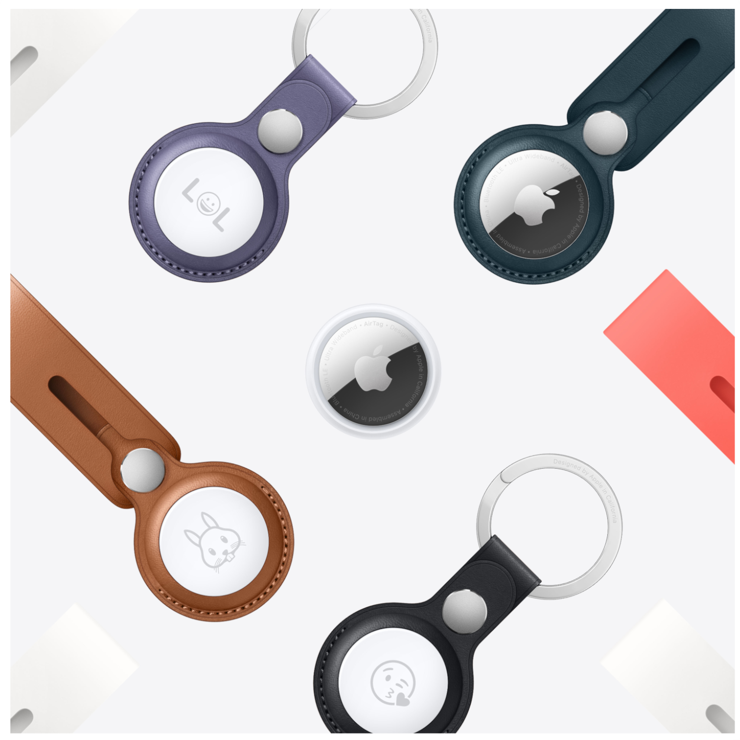 AirTag sleutelhangers en Apple AirTag, met gegraveerde gezichten: LOL, een konijn, een kussend gezicht en een smiley.