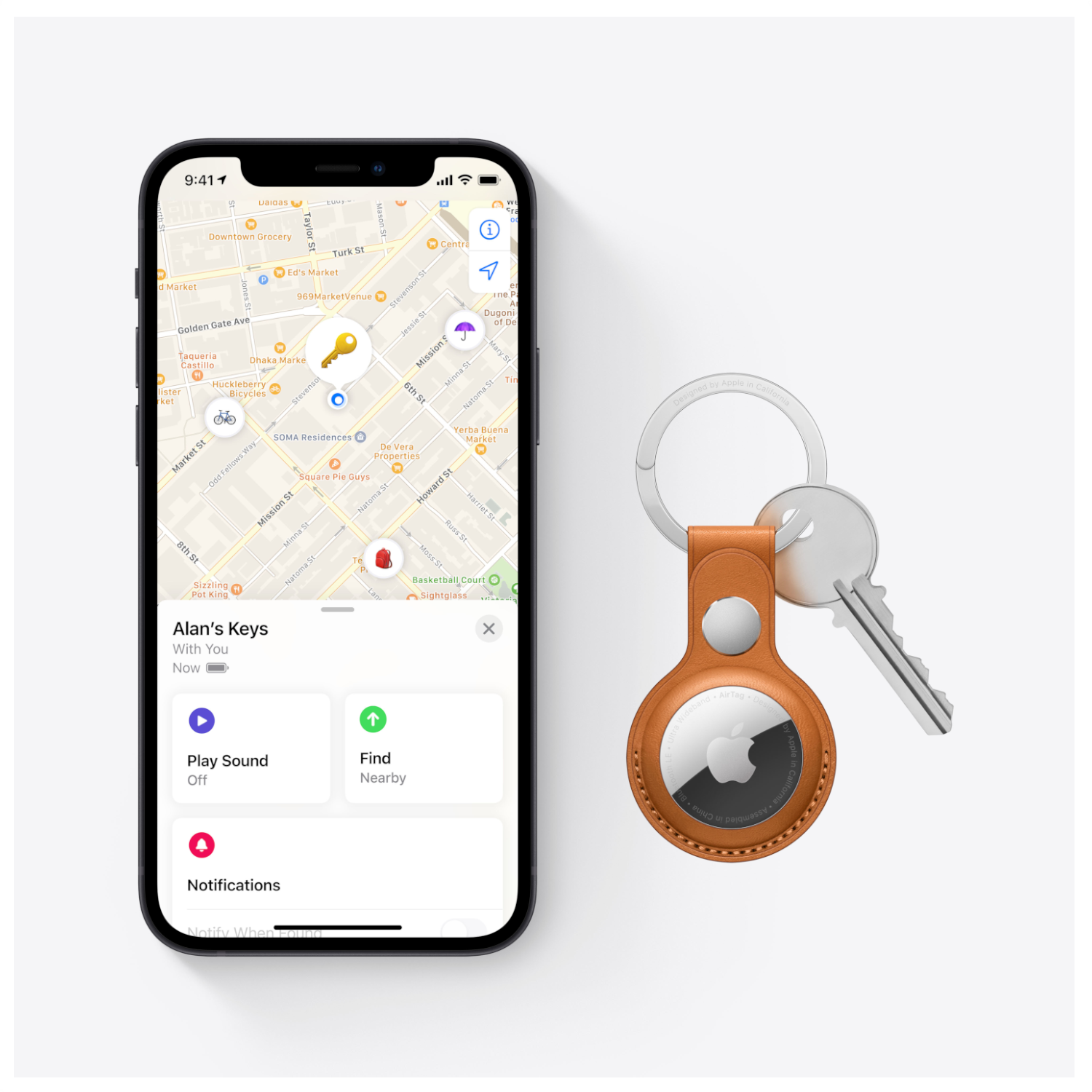 A phone showing a map with a key finder and keys attached. The phone shows a map.