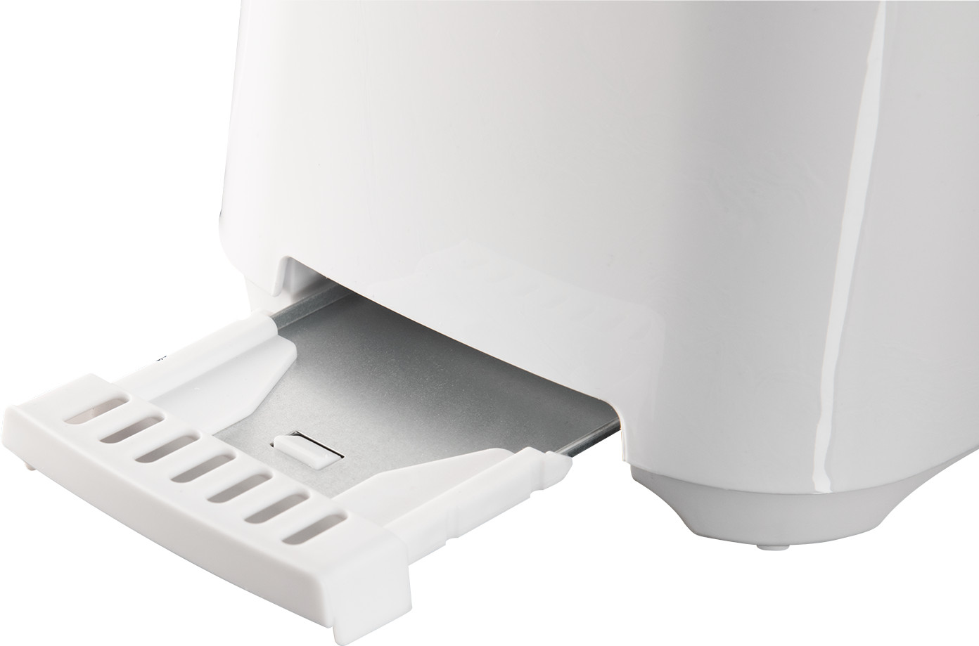 Close up of a white toaster with the crumb tray pulled out.