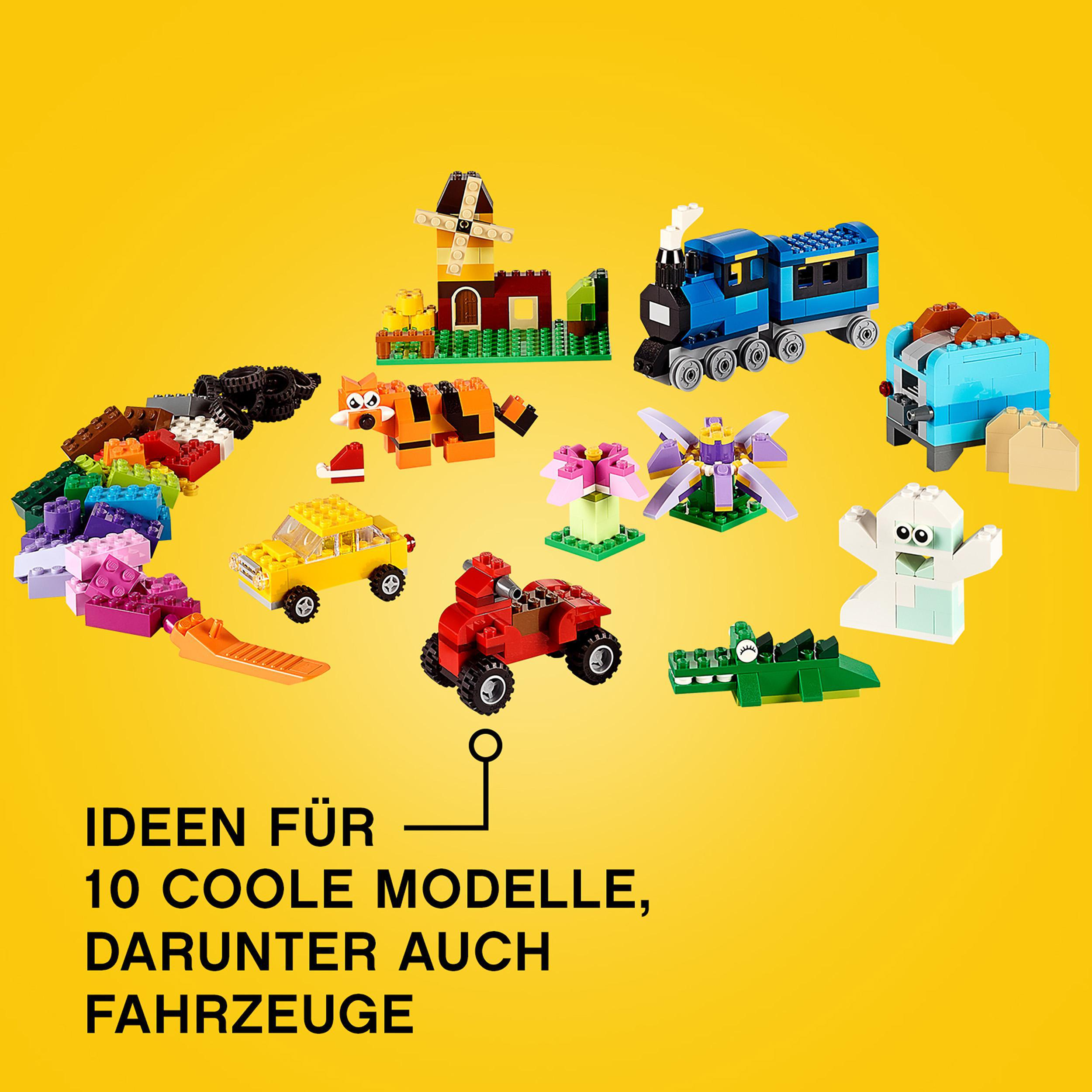 LEGO-Set auf gelbem Hintergrund. Enthält verschiedene Modelle wie Zug, Auto und Tierfiguren.