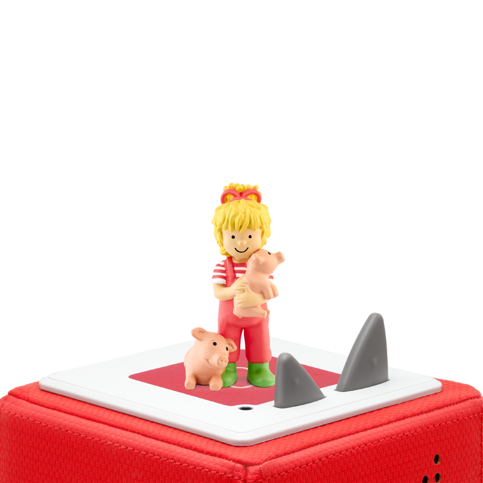 Ein Mädchen mit zwei Schweinen auf einer roten Oberfläche. Haifischflossen im Hintergrund.