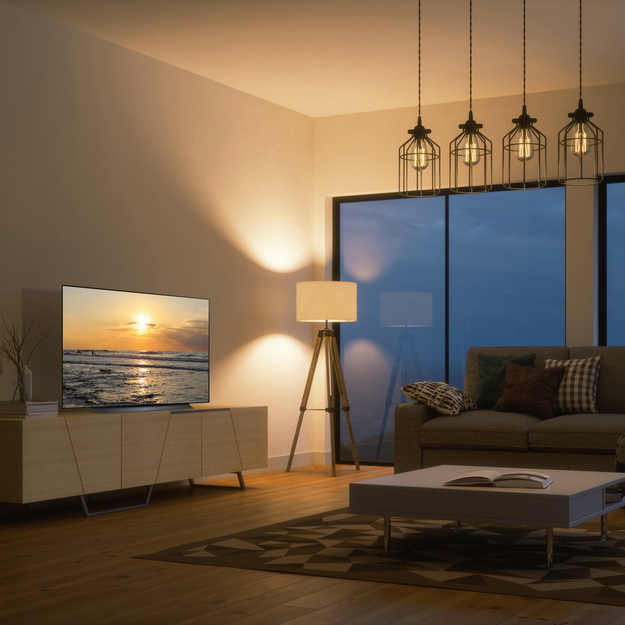 Salón con TV mostrando atardecer. Sofá, lámpara y vista al mar. Diseño moderno.