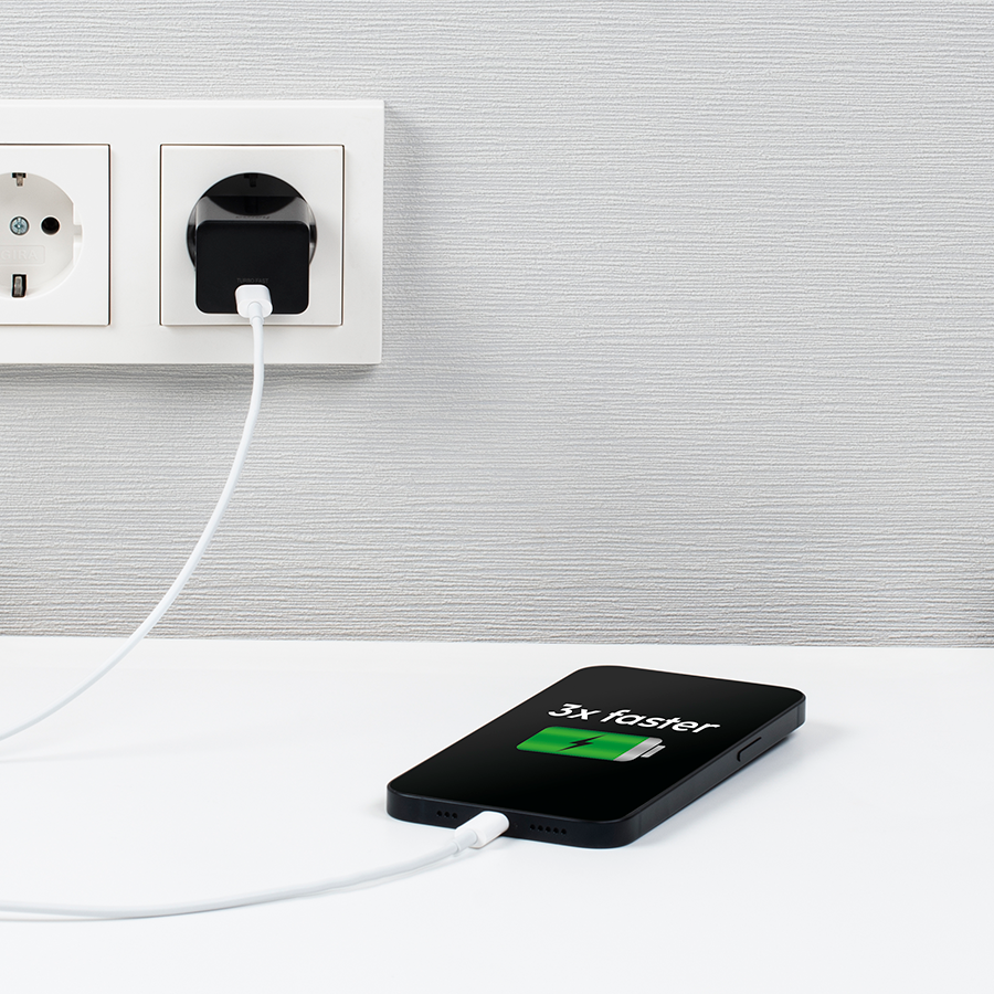 Phone charging with white cable, plugged into a wall socket. Shows 3x faster charging on the screen.