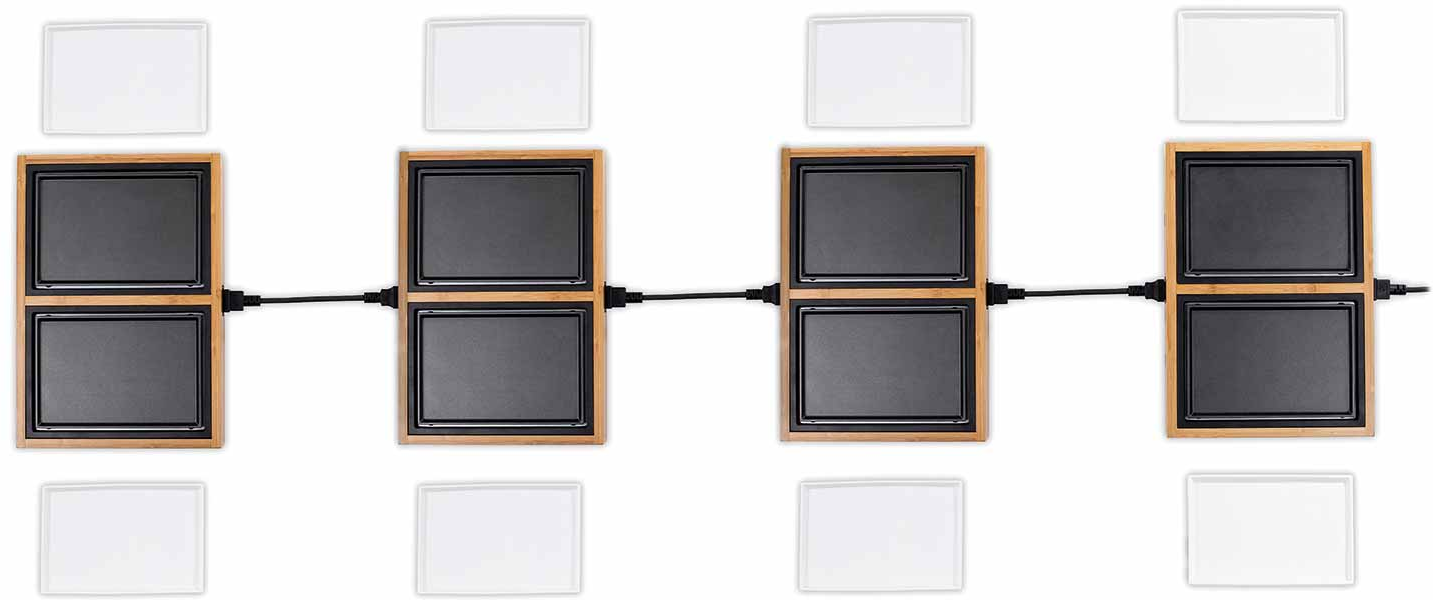 Quatre surfaces de cuisson noires et en bois connectées avec des assiettes blanches au-dessus et en dessous.