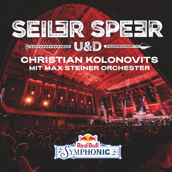 Konzertszene. Red Bull Symphonic Logo. Bühnenlichter beleuchten die Menge.