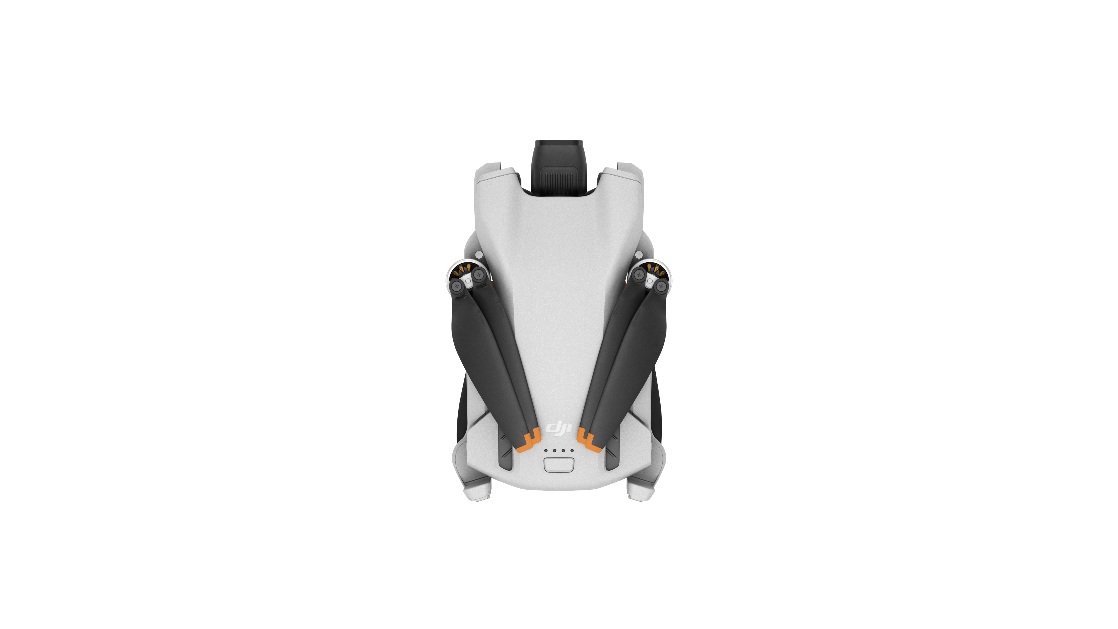 Egy fehér drón felülről fekete légcsavarokkal és DJI logóval, fekete háttérrel.