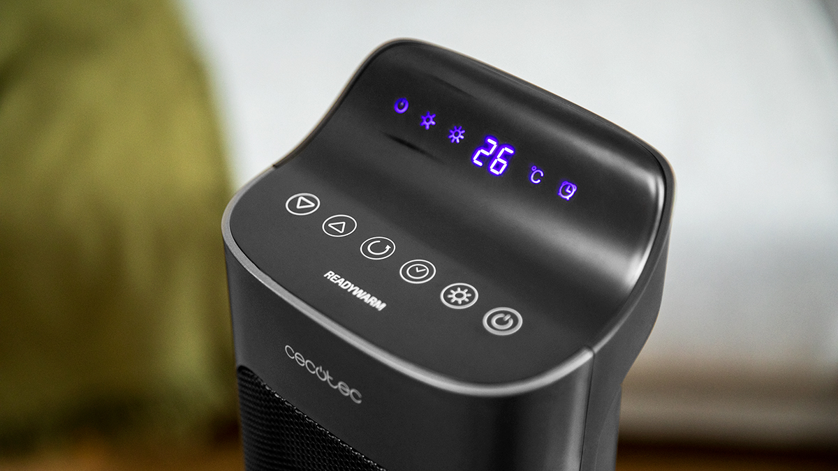 Calentador ReadyWarm negro con pantalla digital que muestra 26 grados Celsius. Botones de encendido, configuración y temporizador visibles.