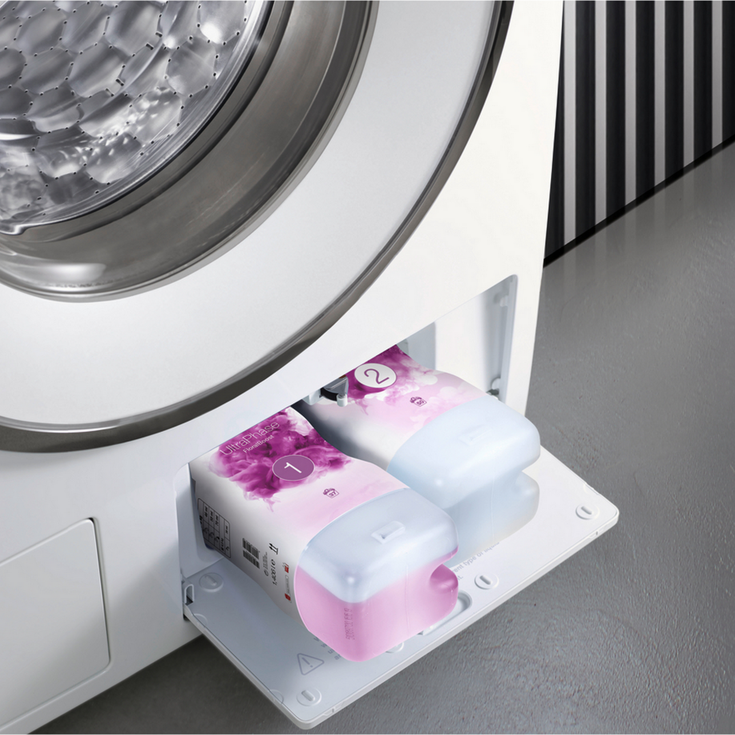 A washing machine with two detergent containers. The containers are labeled with numbers and colors.