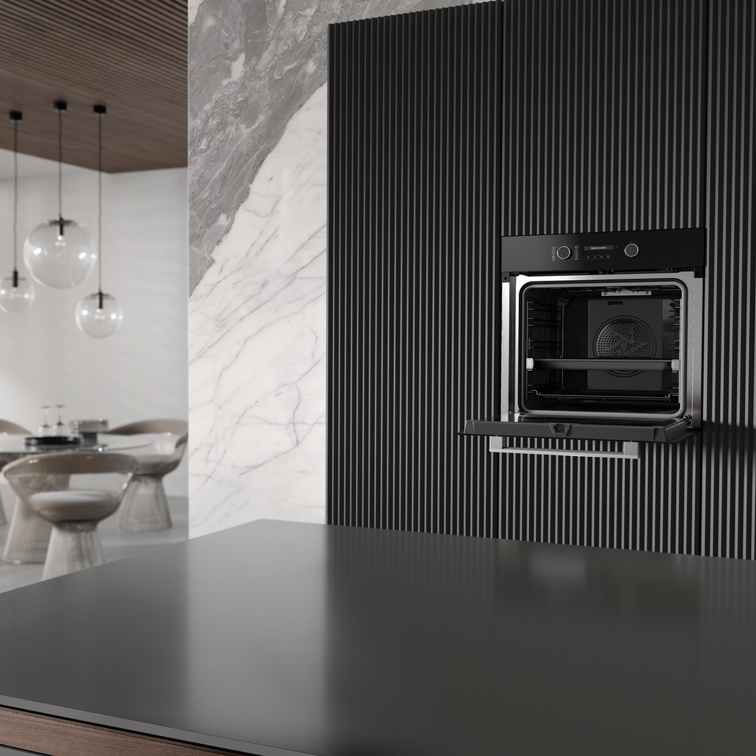 An oven built into a black wall, oven door open, with a kitchen in the background.