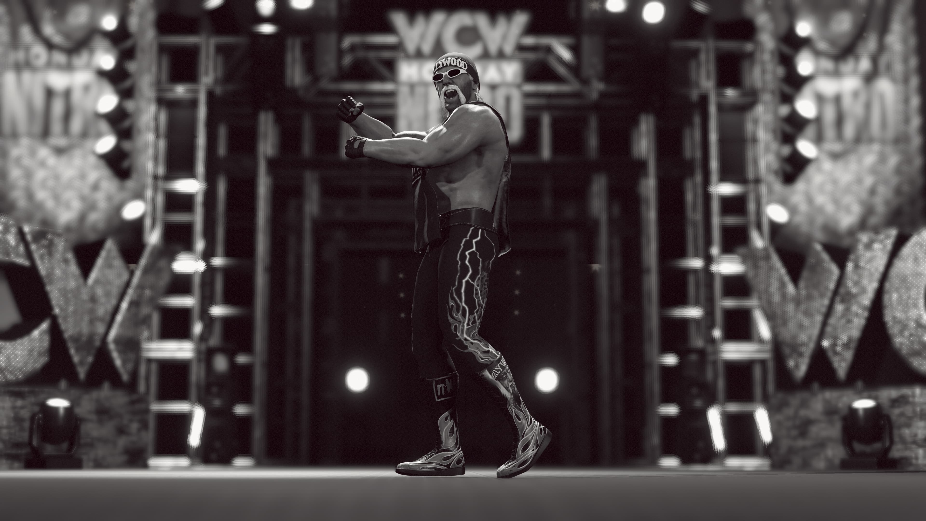 Hulk Hogan dans un ring de catch, en noir et blanc. Il pose les bras tendus.