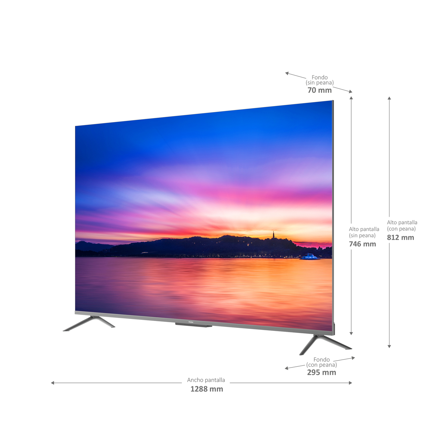 Televisor grande en un soporte. La pantalla muestra una colorida puesta de sol sobre agua y montañas.