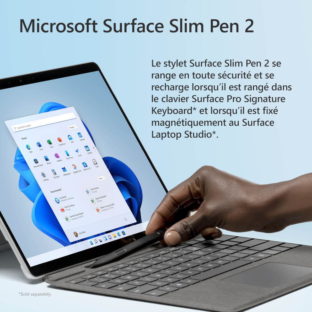 A person using a Microsoft Surface Slim Pen 2 on a laptop showing the Windows interface.