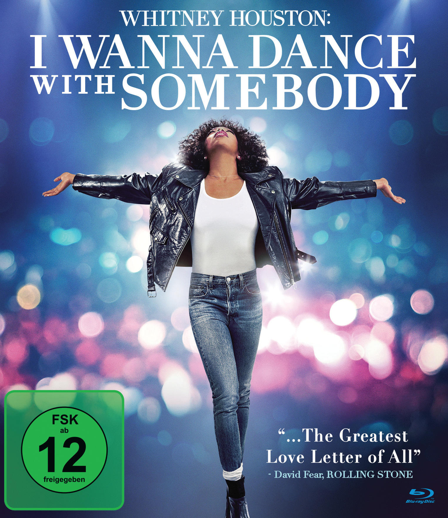 Whitney Houston auf einem Filmplakat. Sie trägt eine Lederjacke und Jeans, Arme ausgestreckt. Text: I Wanna Dance With Somebody.