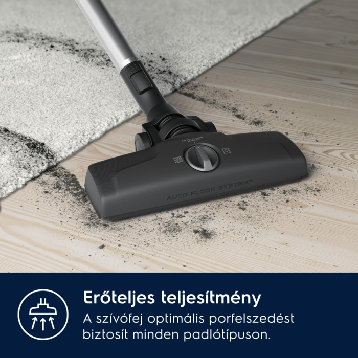 Porszívófej a fa padlón. Szennyeződés szórva. Magyar szöveg: erőteljes teljesítmény.