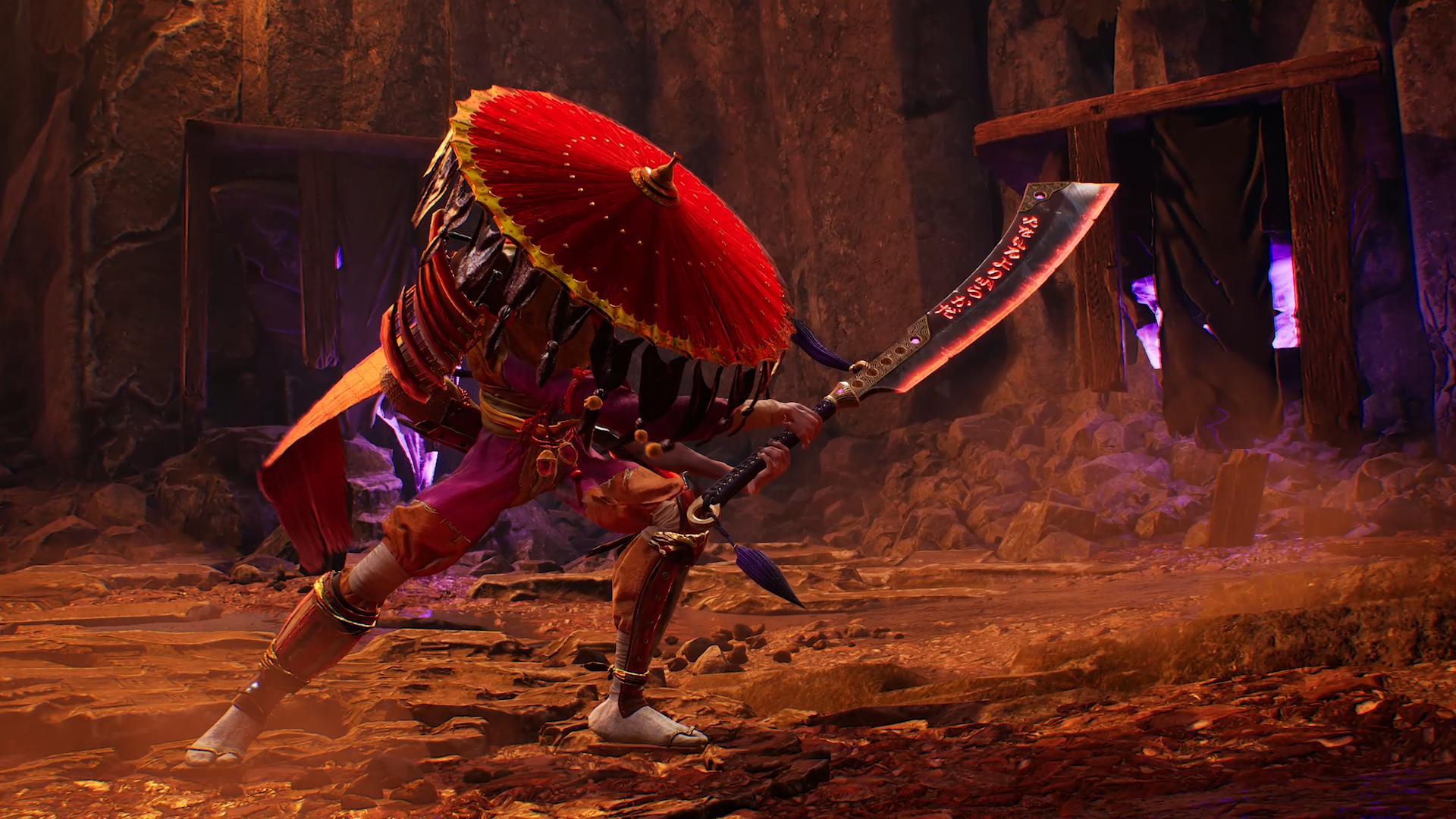 Un personaje con atuendo y sombrero rojos empuñando una espada grande. La escena tiene un entorno oscuro y rocoso.