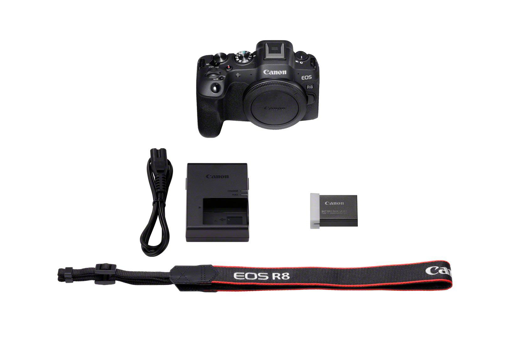 Draufsicht auf eine Canon EOS R8 Kamera mit Zubehör: Ladegerät, Akku, Gurt und Kabel.