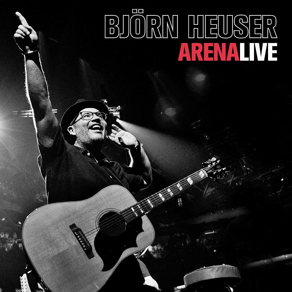 Mann mit Gitarre auf der Bühne, zeigt nach oben, Text 'Björn Heuser Arena Live'.