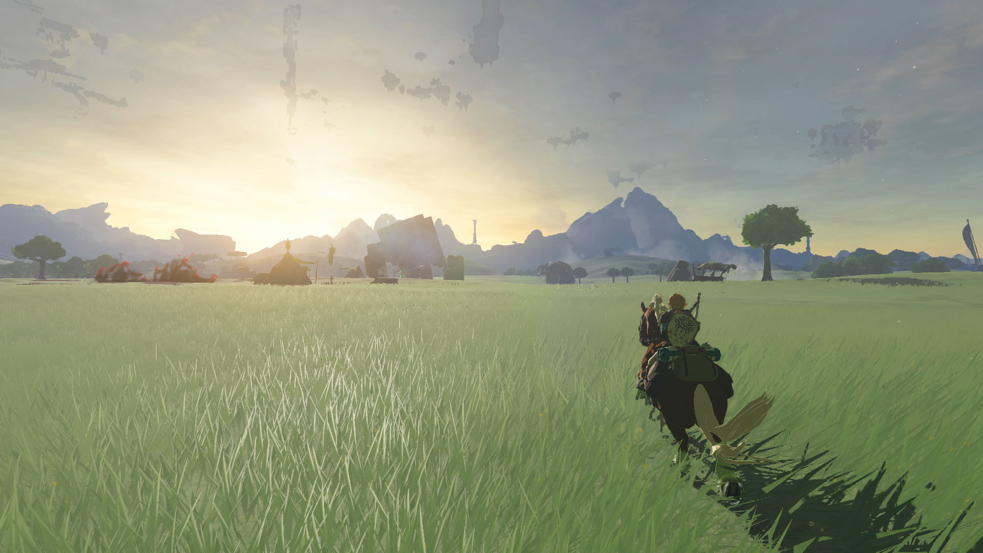 A person riding a horse through a field at sunset.