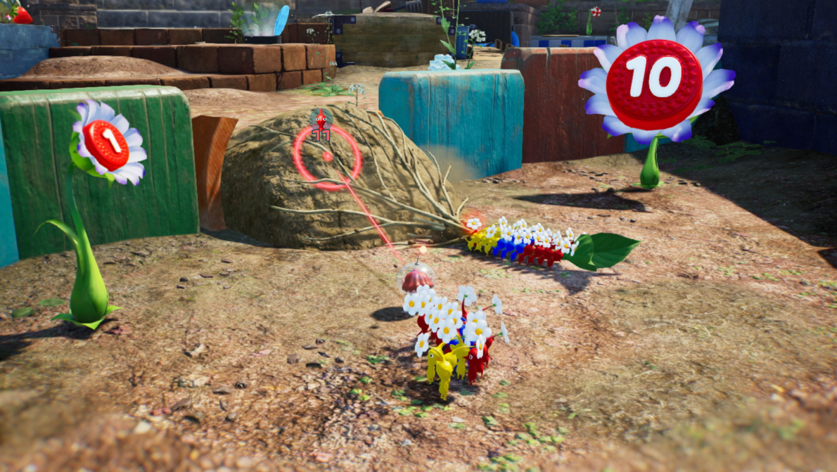 Eine Spielszene mit blumenförmigen Punktemarkierungen, Holzblöcken und einem kleinen Charakter.
