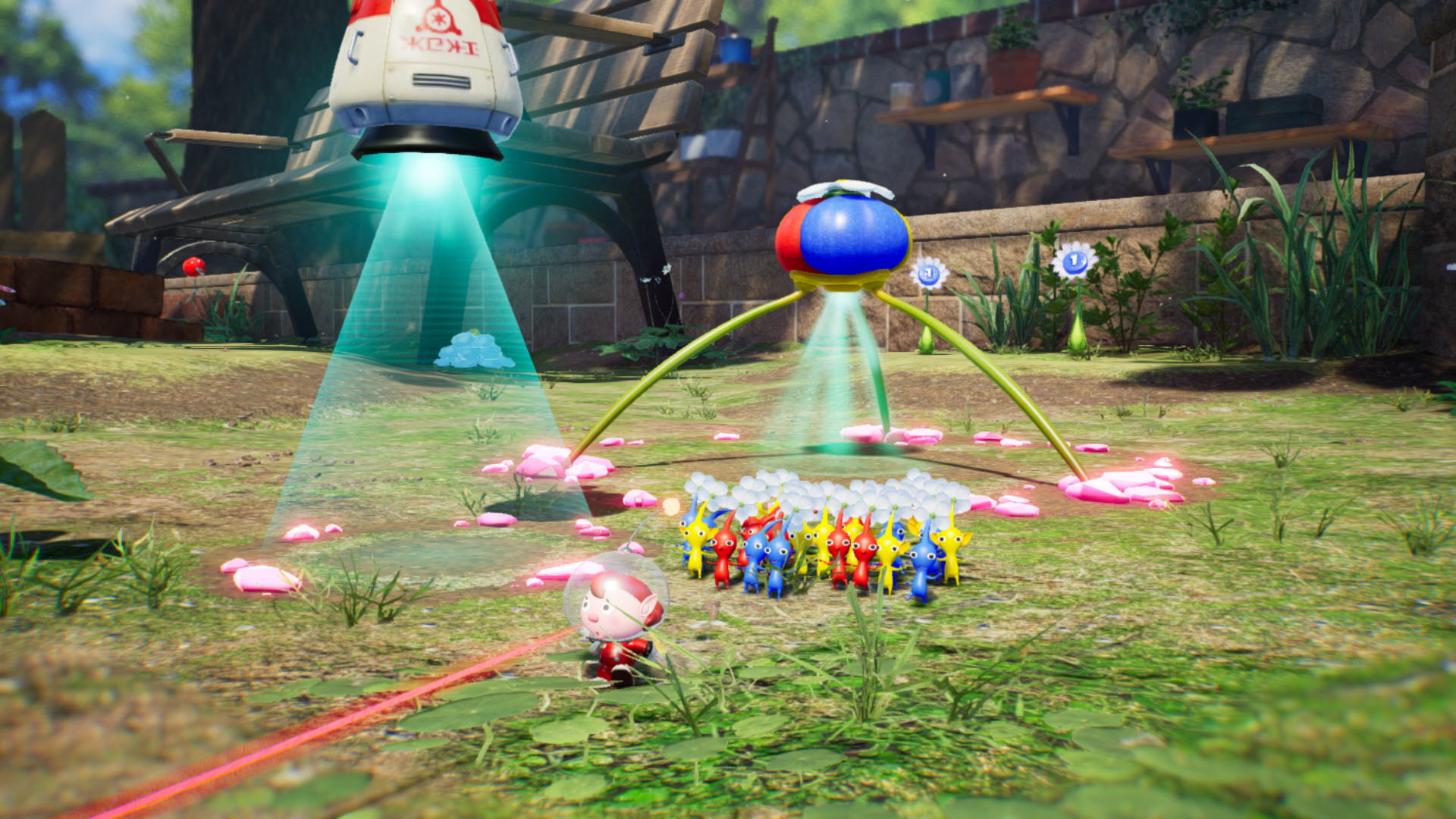 Una scena di gioco con un'astronave, una macchina volante e piccole creature colorate.
