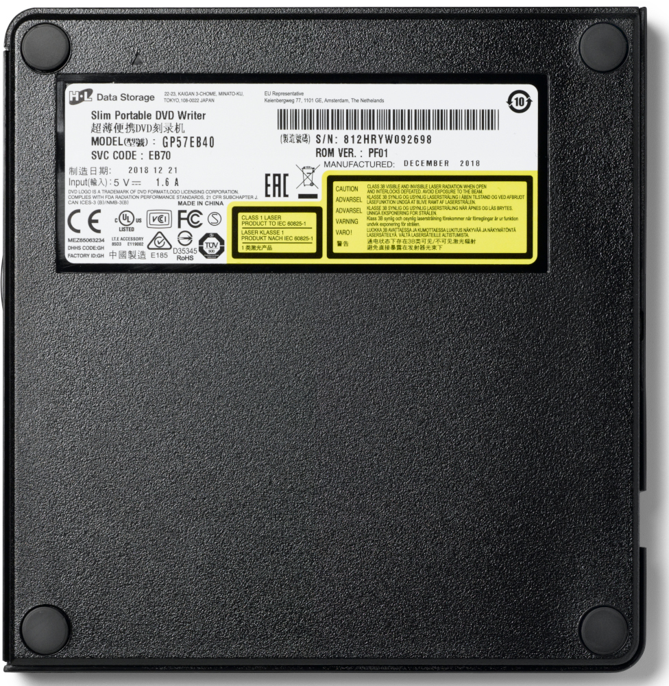 Black portable DVD writer with labels. Top view. Black surface. White background.
