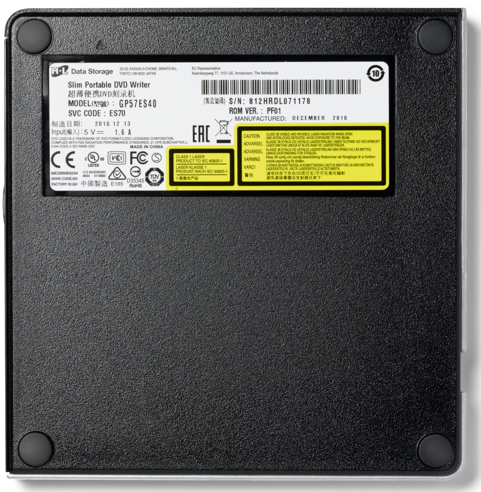 Black portable DVD writer with labels and logos on a gray surface.