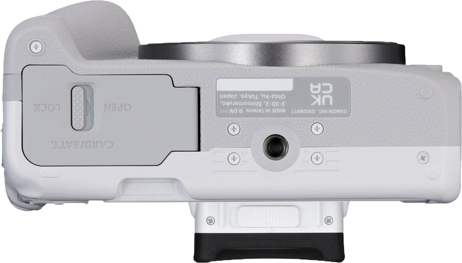 Top view of a white camera with a black lens, battery compartment, and various buttons.