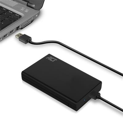 Un disque dur externe noir connecté à un ordinateur portable via un câble USB. Sur une surface blanche.