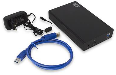 Un disque dur externe noir avec un adaptateur secteur et des câbles sur une surface blanche.